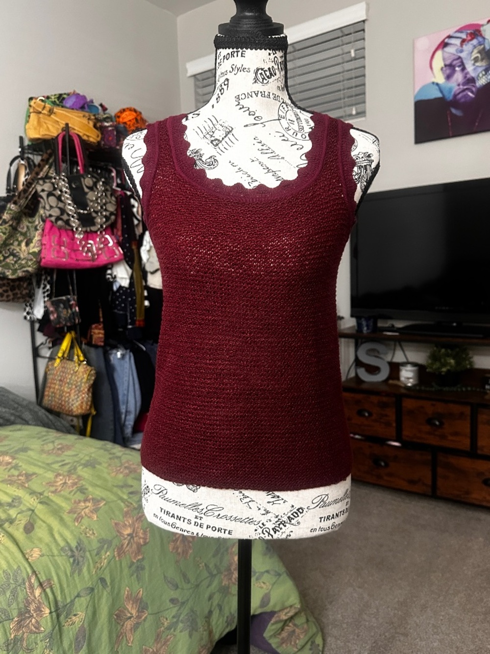 Burgundy knit tank top with scalloped hem.
